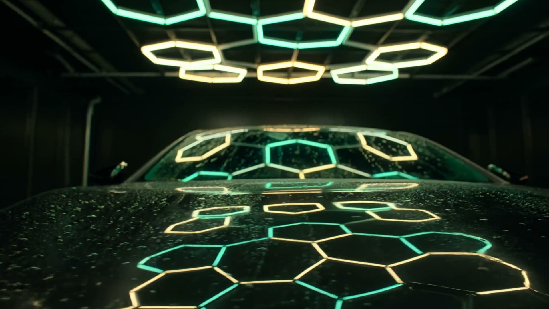 Macro shot gliding across the wet black hood of a car, hexagonal honeycomb studio lights reflected in the mirror finish.